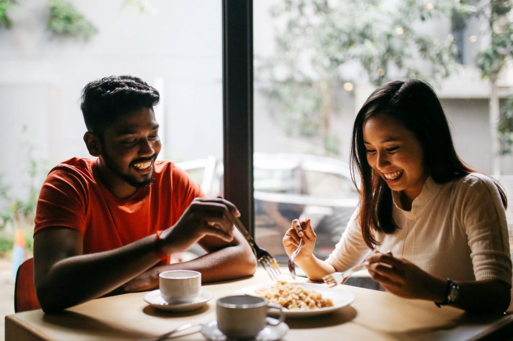 A couple eating happily in a restaurant