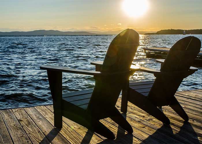 2 chairs by lakefront home in the horizon